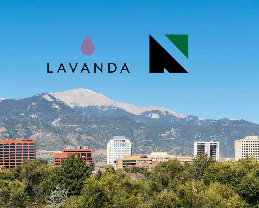 The Lavanda and Nexus marks above Colorado Springs, the Rocky Mountains rising behind the city.