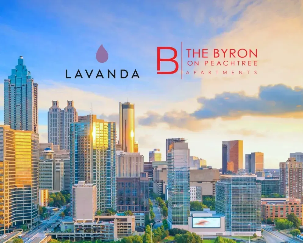 The Lavanda and The Byron on Peachtree marks above the Atlanta skyline at golden hour.