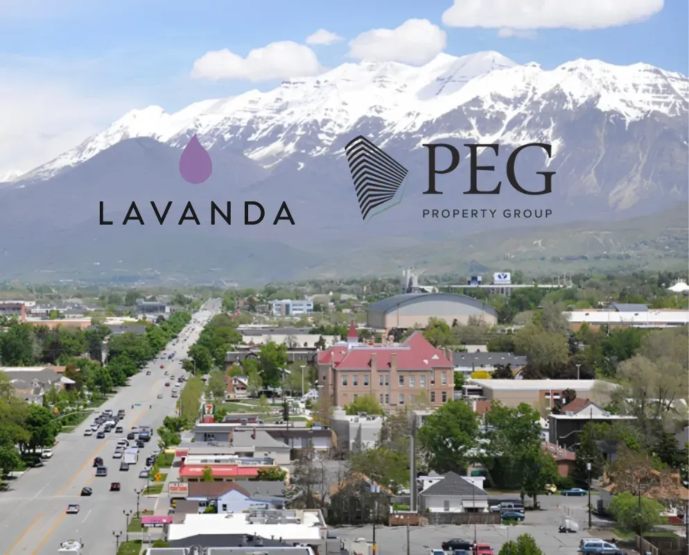 The Lavanda and PEG Property Group marks above a valley town with snow-capped mountains behind.